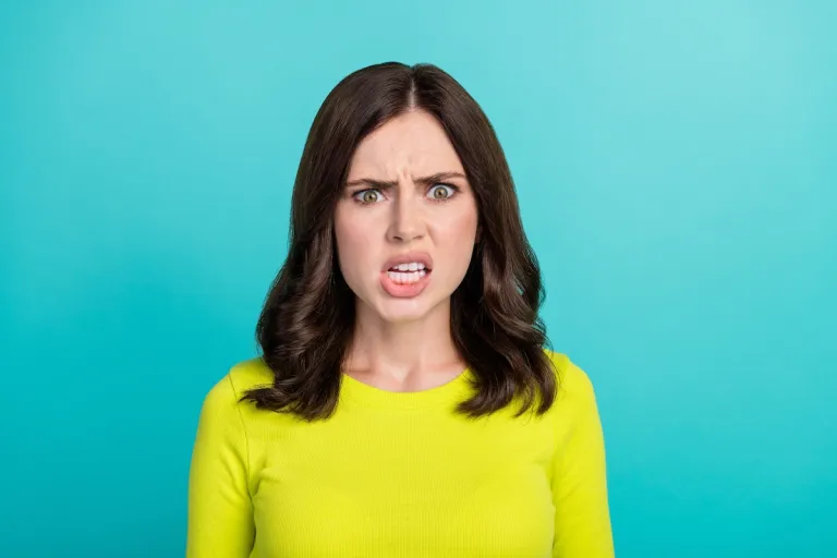 frustrated woman neon green shirt | MercerOnline