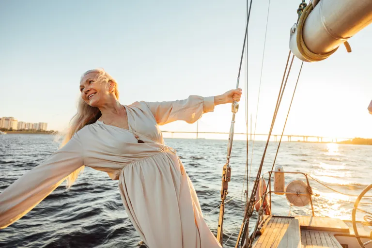 mature woman in dress on sail boat | MercerOnline