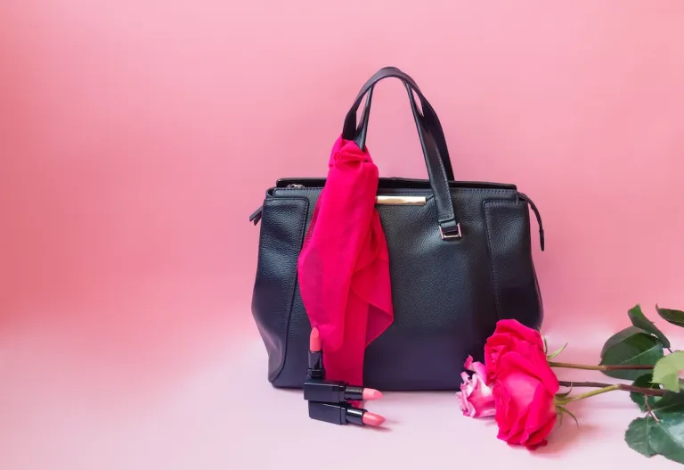 pink scarf tied to black purse | MercerOnline
