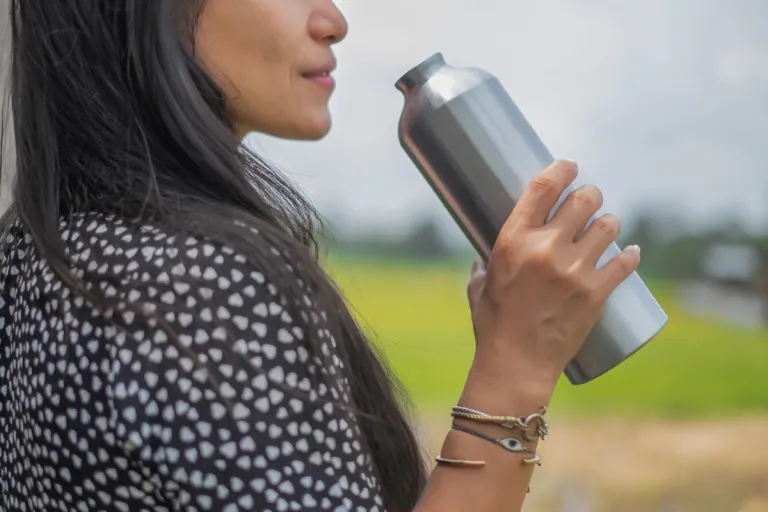 woman smelling water bottle | MercerOnline