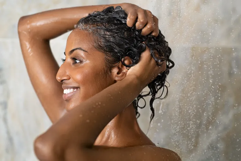 woman washing hair in shower | MercerOnline